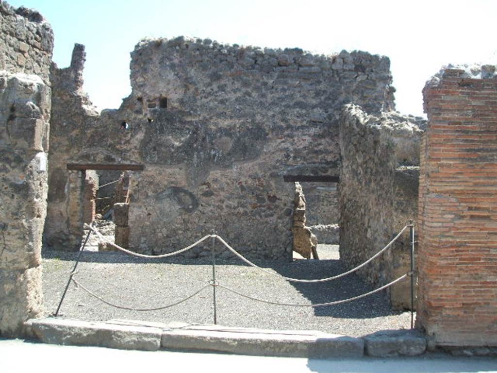 I.4.17 Pompeii. May 2005. Entrance on Via dellAbbondanza. Looking south.
Two large terracotta dolia were found buried in the soil of the shop-room. They contained farina molita (flour) that Fiorelli thought was probably sold from there. They are no longer visible.
See Pappalardo, U., 2001. La Descrizione di Pompei per Giuseppe Fiorelli (1875). Napoli: Massa Editore. (p.43).

According to Della Corte, on the pilaster to the right of the shop, CIL IV 768 was found:
M.  Epidium  Sabinum  d(uumvirum) i(ure) dic(undo) o(ro) v(os) f(aciatis) dignus  est defensorem  coloniae  ex  sententia  Suedi  Clementis  sancti  Iudicis consensu  ordinis,  ob  merita  eius  et  probitatem  dignum  rei publicae  faciat(is)  Sabinus  dissignator  cum  Plausu  facit.  
See Della Corte, M., 1965.  Case ed Abitanti di Pompei. Napoli: Fausto Fiorentino. (p. 244, 
together with Note 1  which says For the precise topography of this programme, see PAH II, p.571)

