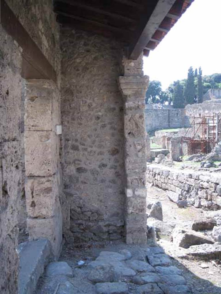 I.5.1 Pompeii. September 2010. Right (west) ante of restored portico looking west along Vicolo del Conciapelle towards Via Stabiana (entrance left of image).  Photo courtesy of Drew Baker.
