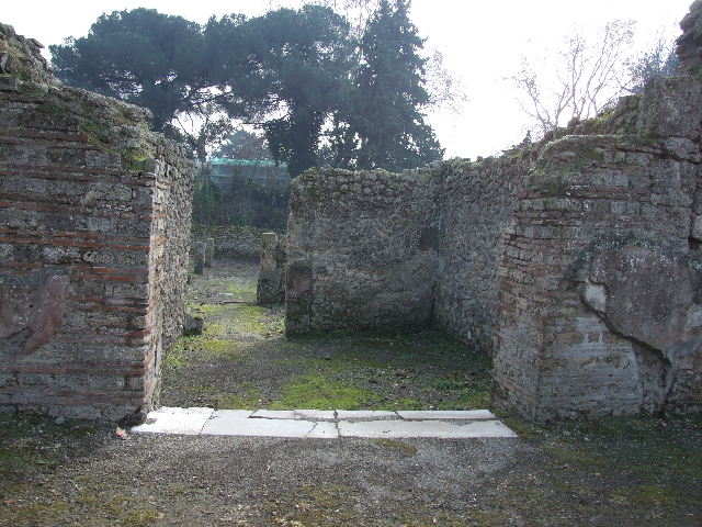 I.5.2 Pompeii. September 2010. Looking north across shop-room towards entrance doorway looking onto Vicolo del Conciapelle. The doorway on the right (east side) leads to a small area beneath the stairway. Photo courtesy of Drew Baker.

