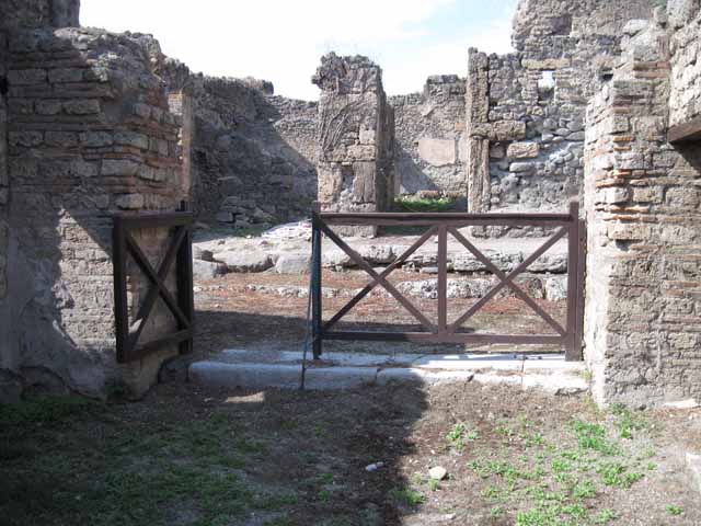 I.5.2 Pompeii. September 2010. Doorway to room on west side of shop-room. Photo courtesy of Drew Baker.
