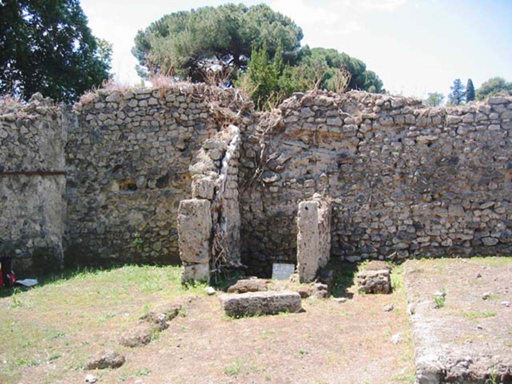 I.5.2 Pompeii. July 2008. Looking west to south-west corner and west wall of peristyle area, showing small room with latrine.  Photo courtesy of Barry Hobson.
