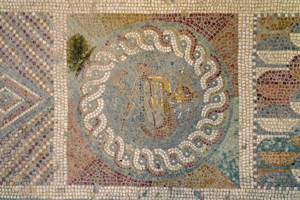 I.6.2 Pompeii. December 2015. Detail of mosaic panel with swords, shield and helmet.
In threshold or sill between antecamera and oecus/triclinium in south-east corner of the east wing. 
