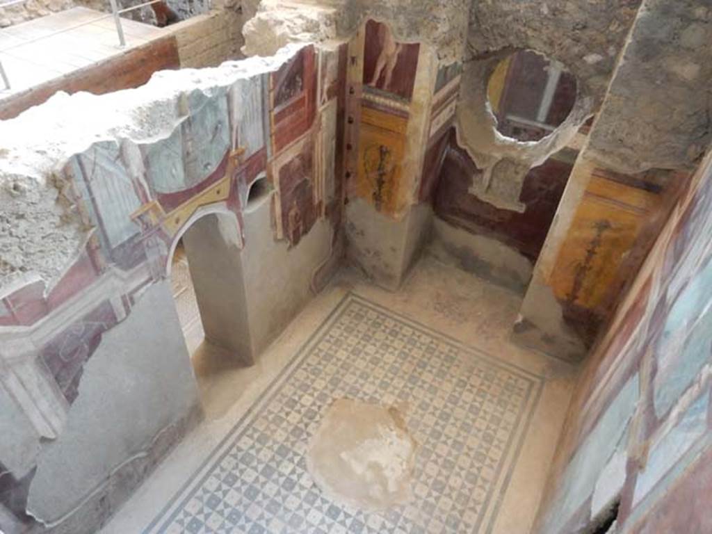 I.6.2 Pompeii. May 2006. West wall of frigidarium. Niche in west wall with paintings of candelabra and cupid. At the rear through the hole, the west wall of the east wing of the cryptoporticus can be seen.