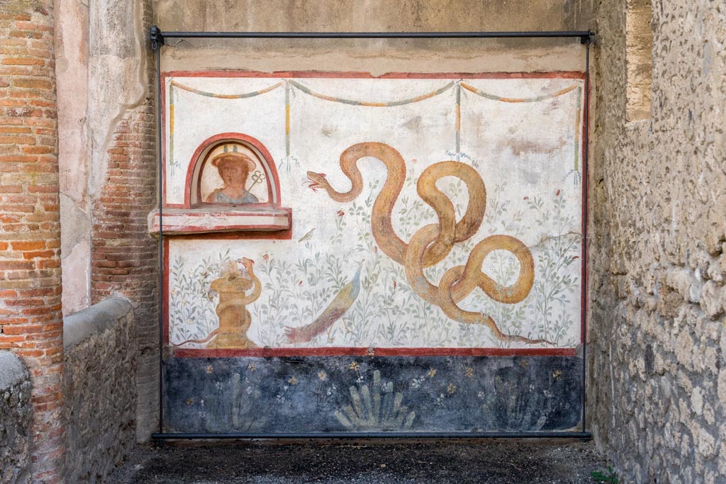 I.6.2 Pompeii. October 2023. Painted lararium on west wall near portico. Photo courtesy of Johannes Eber.