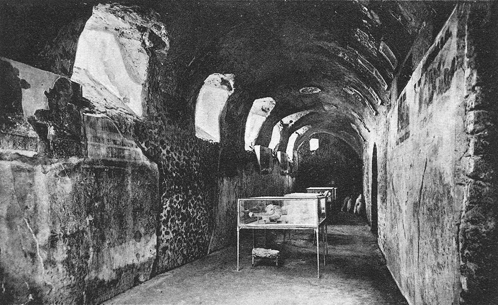 I.6.2 Pompeii. Old photograph c. 1920 of cryptoporticus with body casts in glass cases. Looking west along north wing.