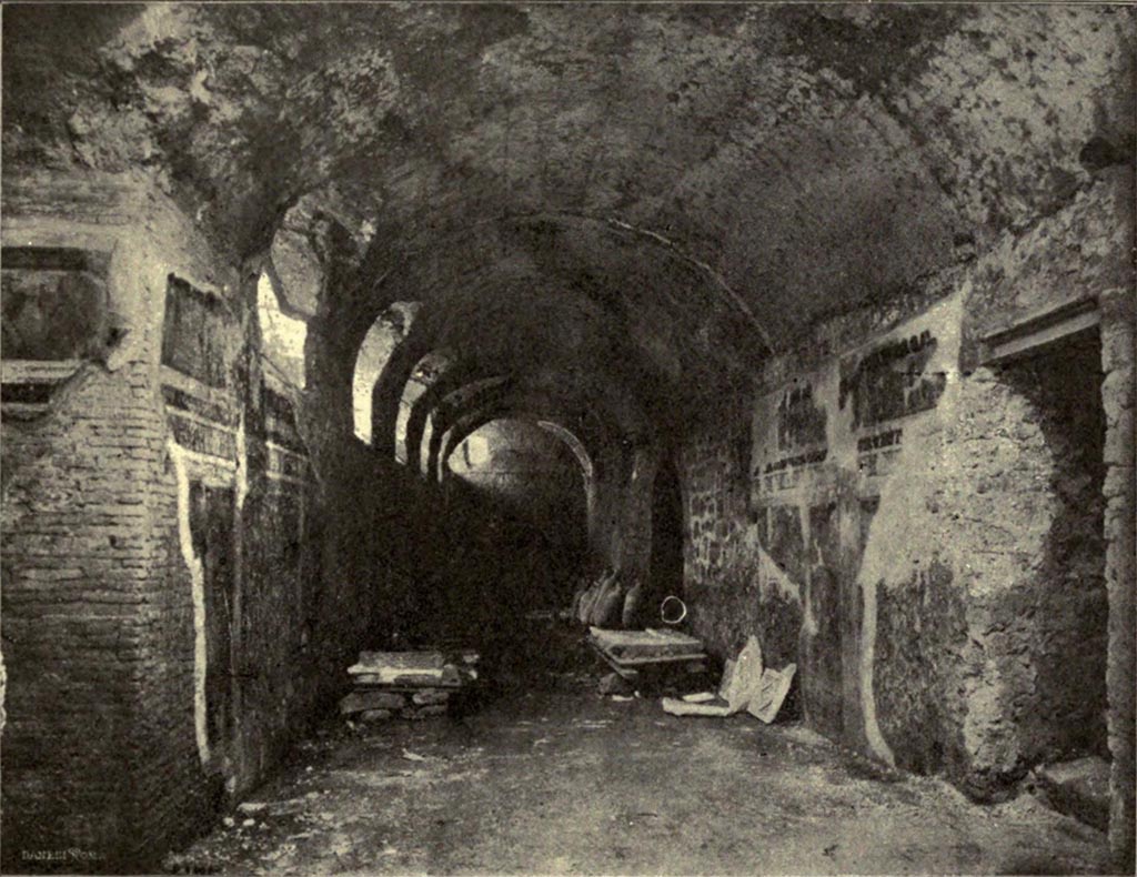 I.6.2 Pompeii. Old photograph c. 1920 of Cryptoporticus with body casts in glass cases.
Looking west along north wing.
