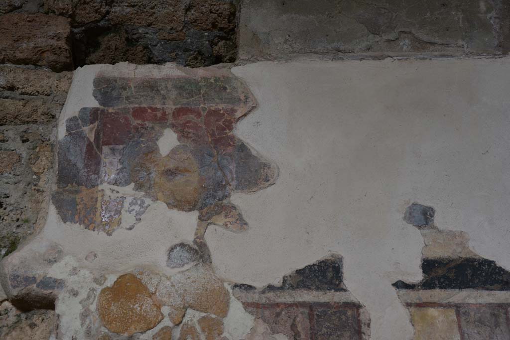 I.6.2 Pompeii. September 2019. Detail from north wall of north wing of cryptoporticus. Photo courtesy of Klaus Heese.
According to PPM, this frieze continues to show scenes from the Iliad. 
On the left is the head of a maenad.
After a gap, the iliac narrative continues with the exchange of weapons between Glaucus and Diomedes, whose name is recorded at his feet in Greek.
On the right, is a fighter on a chariot, assisted by a cloaked figure. 
Diomedes can be recognized, who, assisted by Athena, fights Ares or Aeneas.
See Carratelli, G. P., 1990-2003. Pompei: Pitture e Mosaici: Vol. I.  Roma: Istituto della enciclopedia italiana, p. 204. 
