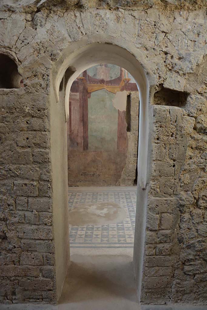 I.6.2 Pompeii. August 2021. Looking east across ornate flooring in oecus/triclinium. Photo courtesy of Robert Hanson.
At the threshold of the oecus/triclinium and the antecamera are a series of different multi-coloured mosaic panels, one with swords, shield and helmet.
