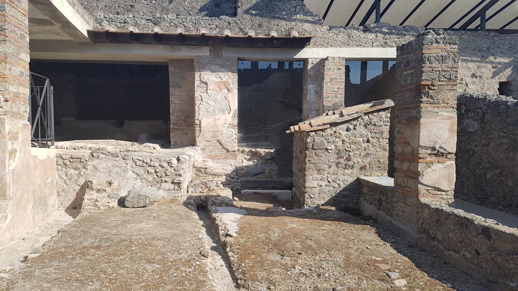 I.6.7 Pompeii. August 2023. Looking south across small peristyle area towards rear rooms. Photo courtesy of Maribel Velasco.