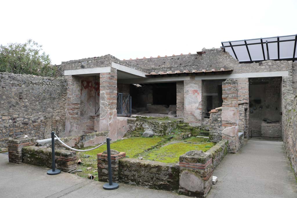 I.6.7 Pompeii. December 2018. Looking south to small, covered area and west end of kitchen. Photo courtesy of Aude Durand.