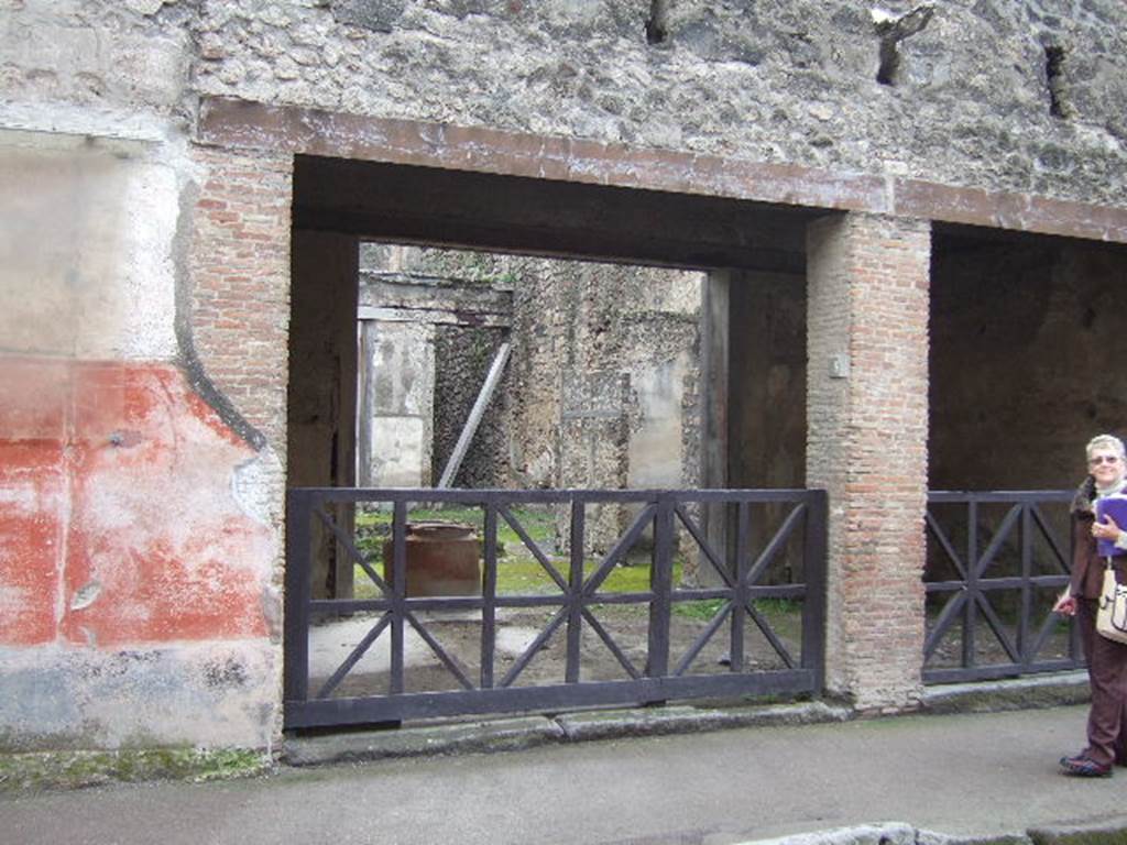 I.6.8 Pompeii. December 2005. Entrance left and I.6.9 right.  Holes for supports of a balcony or gallery are above the entrances.
