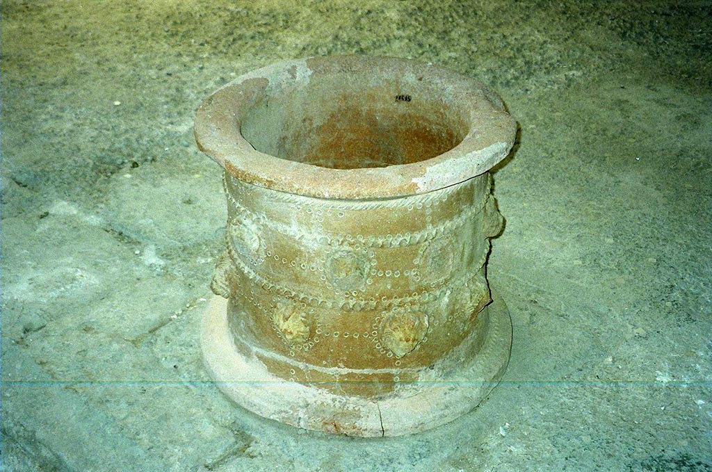 I.6.11 Pompeii. June 2010. 
Terracotta puteal, decorated with heads of lions, originally found on the east side of the peristyle, but now in atrium.
See Bragantini, de Vos, Badoni, 1981. Pitture e Pavimenti di Pompei, Parte 1. Rome: ICCD. (p.36).
See Jashemski, W. F., 1993. The Gardens of Pompeii, Volume II: Appendices. New York: Caratzas. (p.36). Photo courtesy of Rick Bauer.
