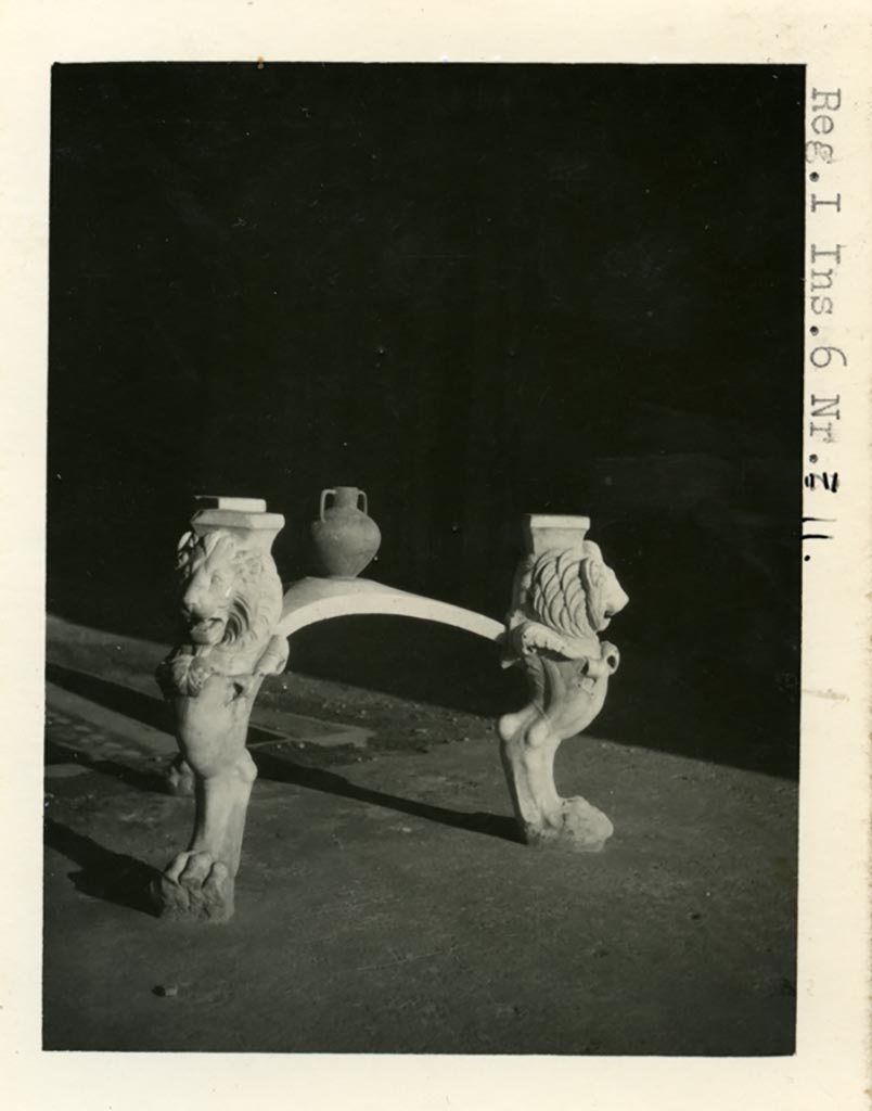 I.6.11 Pompeii. Pre-1937-39. Marble tripod table legs with lion heads and paws, in atrium.
Photo courtesy of American Academy in Rome, Photographic Archive. Warsher collection no. 1850.
