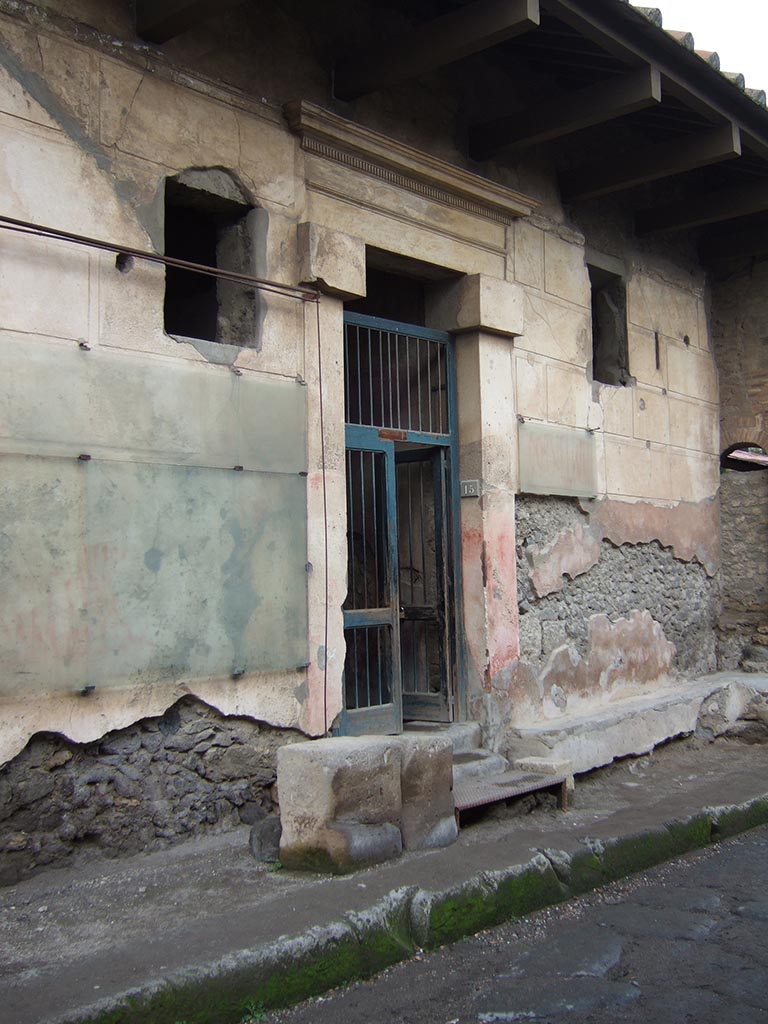 I.6.15 Pompeii. December 2005. Entrance on Vicolo del Menandro.
According to Varone and Stefani, there were many graffiti written on both sides of the doorway.
On the west side (left of the doorway) CIL IV 7187, 7191, 7188 and 7189.
Only part of CIL IV 7188 and 7189 remain on the left.
On the east side (right of the doorway) CIL IV 7190, 7192, 7193 and 7194.
Only part of CIL IV 7190 and 7192 remain on the right.
See Varone, A. and Stefani, G., 2009. Titulorum Pictorum Pompeianorum, Rome: Lerma di Bretschneider, (p.63-68)

According to Epigraphik-Datenbank Clauss/Slaby (See www.manfredclauss.de), these read as:

L(ucium)  Sextilium
IIvir(um)  i(ure)  d(icundo)
[...]  multis  fecit  benigne      [CIL IV 7187]

Cn(aeum)  Helvium  Sabinum  aed(ilem)  Infantio  rog(at)  cum  suis     [CIL IV 7191] 
Translated as
Infantio with his household asks for Cn. Helvius Sabinus as aedile.
See Cooley, A. and M.G.L., 2004. Pompeii: A Sourcebook. London: Routledge. (p.122, F47 CIL IV 7191)

Pansam  aed(ilem)  o(ro)  v(os)  f(aciatis)      [CIL IV 7188]

C(aium)  Iulium
IIvir(um)  Fabia
rog(at)  o(ro)  v(os)  f(aciatis)  dignus  est      [CIL IV 7189]

C(aium)  Cornelium
aed(ilem)  Tyrsus  [ro]gat     [CIL IV 7190]

L(ucium)  Sextilium
o(ro)  v(os)  f(aciatis)      [CIL IV 7192]

Veran[ium]
quinq(uennalem)     [CIL IV 7193]

Q(uintum)  Postumium  Proc[ulum] aed(ilem)  []cei  rog(at)     [CIL IV 7194]
