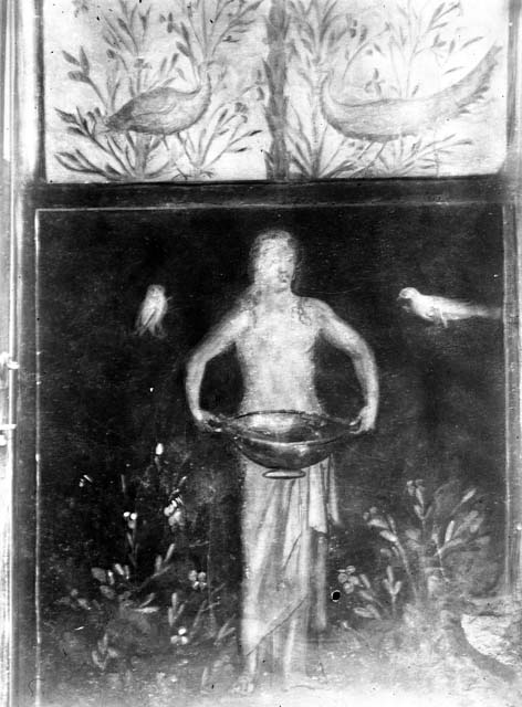 I.6.15 Pompeii. June 2019. Room 9, small garden. 
Wall on west side. Painting with birds, plants and a figure holding a basin or bowl.
Photo by Buzz Ferebee. 
