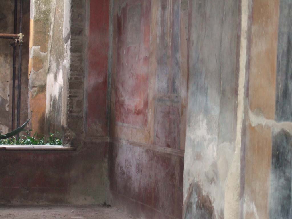 I.7.3 Pompeii. December 2005. West wall of atrium. 
According to Peters, on the left of the west wall was a well-preserved (in 1963) landscape.
He considered the painting very picturesque.
The subject was a temple with a curved roof, standing on a hill against which a tree was growing.
See Peters, W.J.T. (1963): Landscape in Romano-Campanian Mural Paintings. The Netherlands, Van Gorcum & Comp. (p. 153 & fig. 147)
The approximate area of the painting can be seen in the south-west corner, in the upper part of the photo, left of centre.
