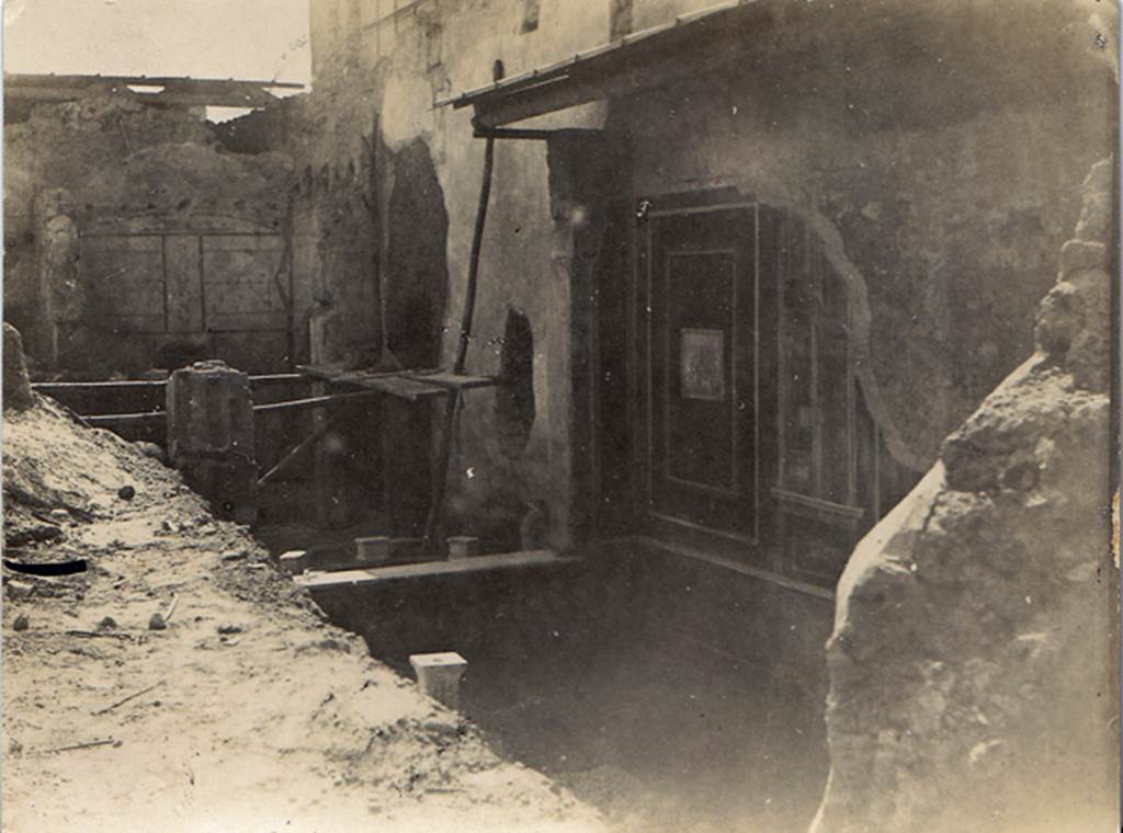 I.7.3 Pompeii. 19th October 1923. Photo courtesy of Drew Baker. West wall of atrium and small peristyle with small semicircular basin in the course of excavation. Photo taken from fauces or entrance corridor.