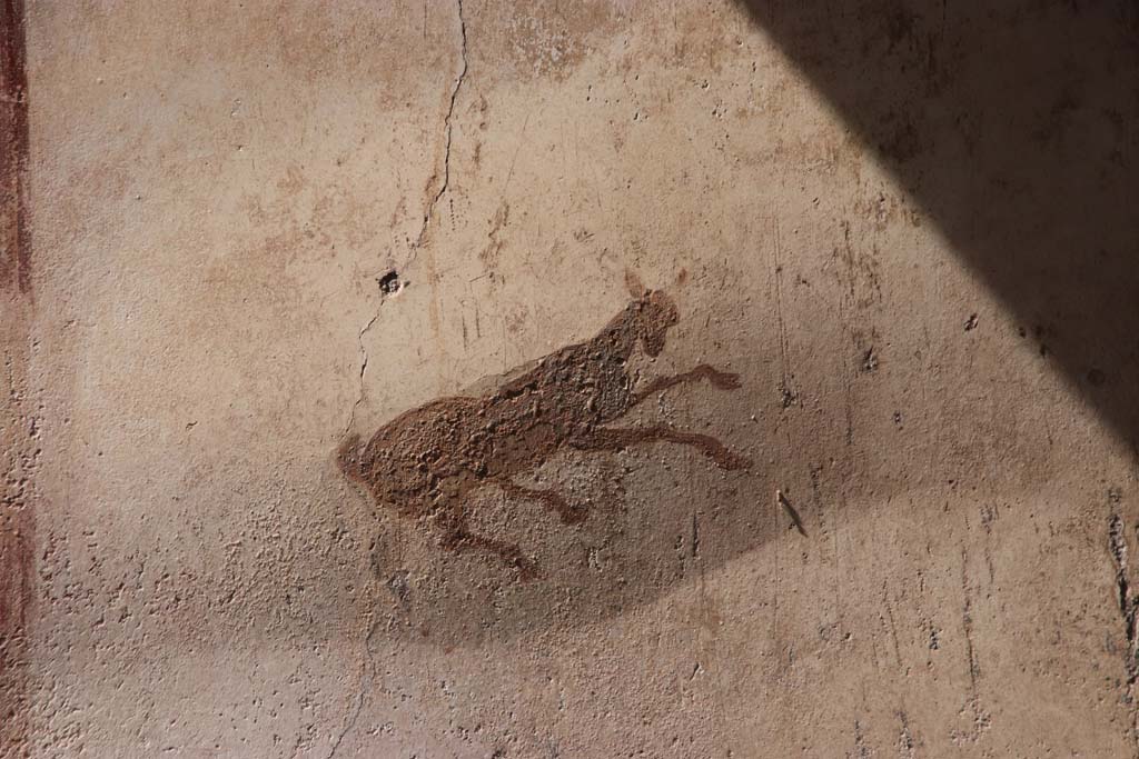 I.7.11 Pompeii. September 2021. Painted decoration in centre of west panel on north wall. Photo courtesy of Klaus Heese.