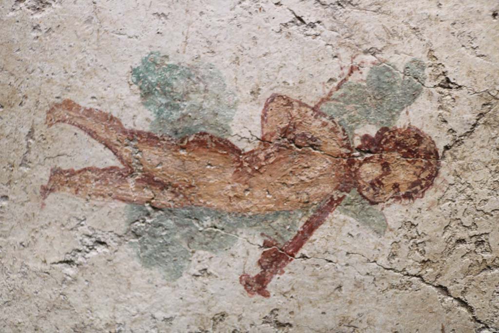 I.7.11 Pompeii. December 2018. 
Detail of wall painting of cupid with sword from south wall of bedroom on west side of atrium.
Photo courtesy of Aude Durand
