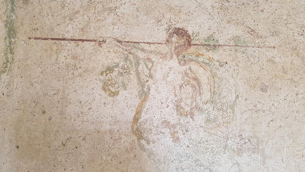 I.7.11 Pompeii. August 2023. Detail of painted figure from centre of middle panel on east wall. Photo courtesy of Maribel Velasco.