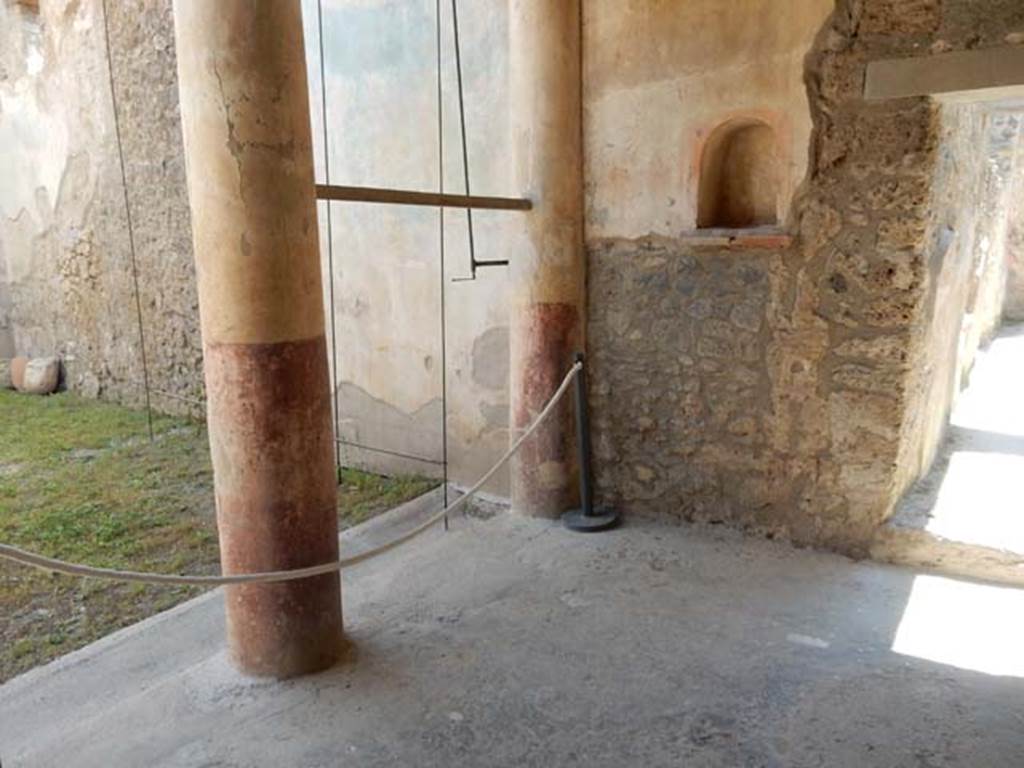 I.7.19 Pompeii. May 2017. 
Looking across north portico towards west wall of garden area with niche, with corridor to atrium area, on right. Photo courtesy of Buzz Ferebee.


