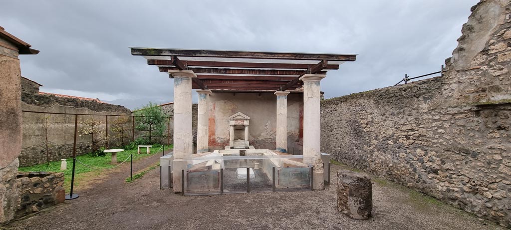 I.7.12 Pompeii. December 2023. Looking south across garden area with summer triclinium. Photo courtesy of Miriam Colomer.