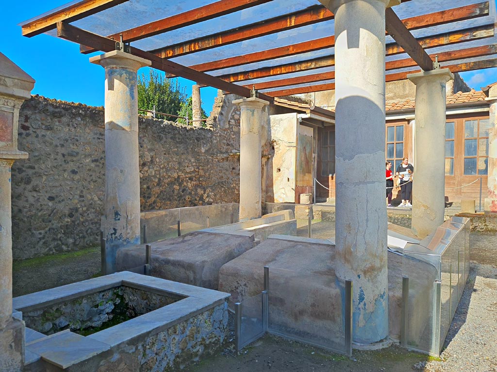 I.7.12 Pompeii. March 2024. Looking north across summer triclinium on west side of garden area. Photo courtesy of Giuseppe Ciaramella.

