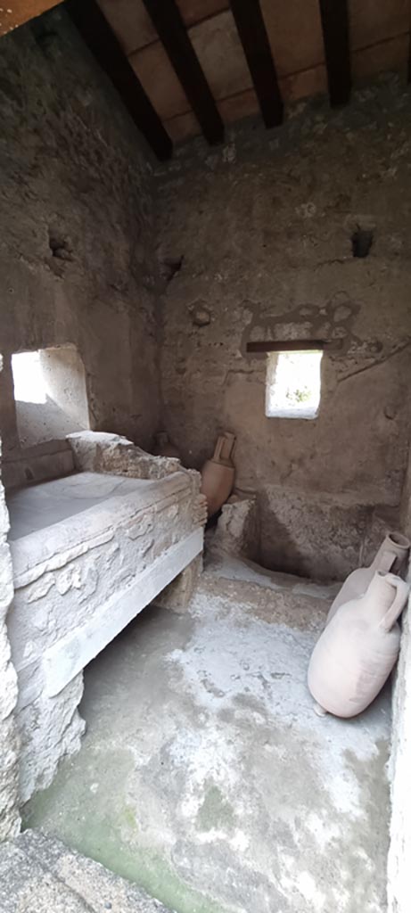 I.7.12 Pompeii. December 2023.
Looking south through doorway into kitchen and latrine. 
Photo courtesy of Miriam Colomer.
