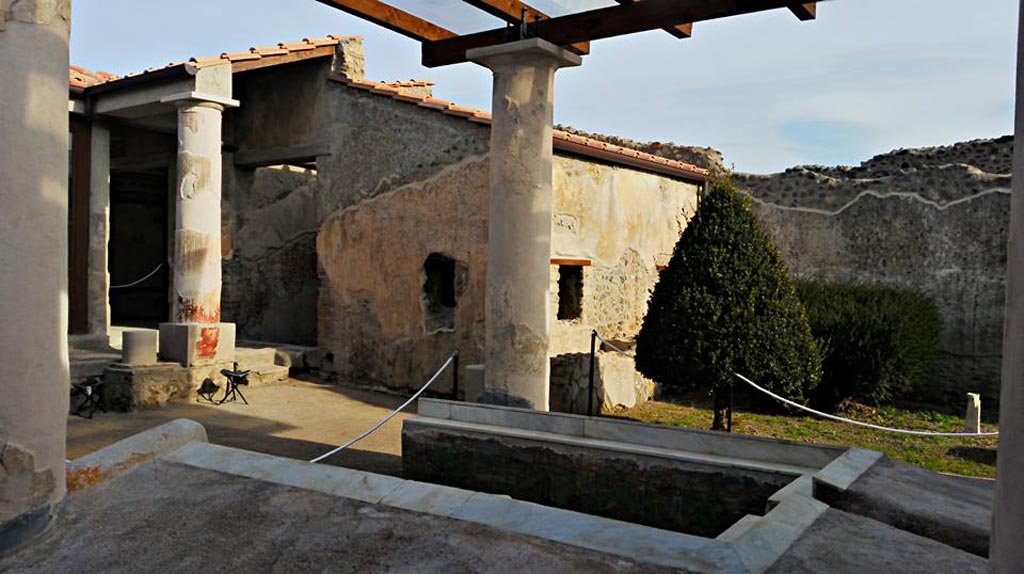 I.7.12 Pompeii. 2015/2016. 
Looking north-east across triclinium in garden towards north portico and window from cubiculum, in centre. Photo courtesy of Giuseppe Ciaramella.
