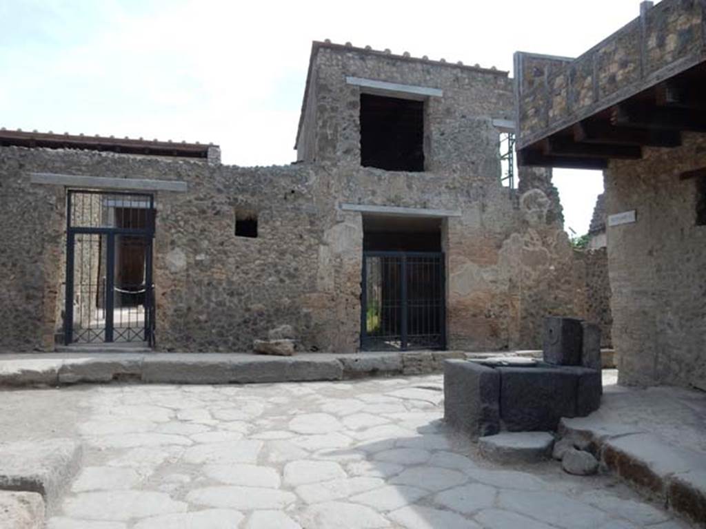 I.7.18 Pompeii, on right. May 2017. East side of Vicolo di Paquius Proculus with doorway to I.7.19, on left.
Photo courtesy of Buzz Ferebee.

