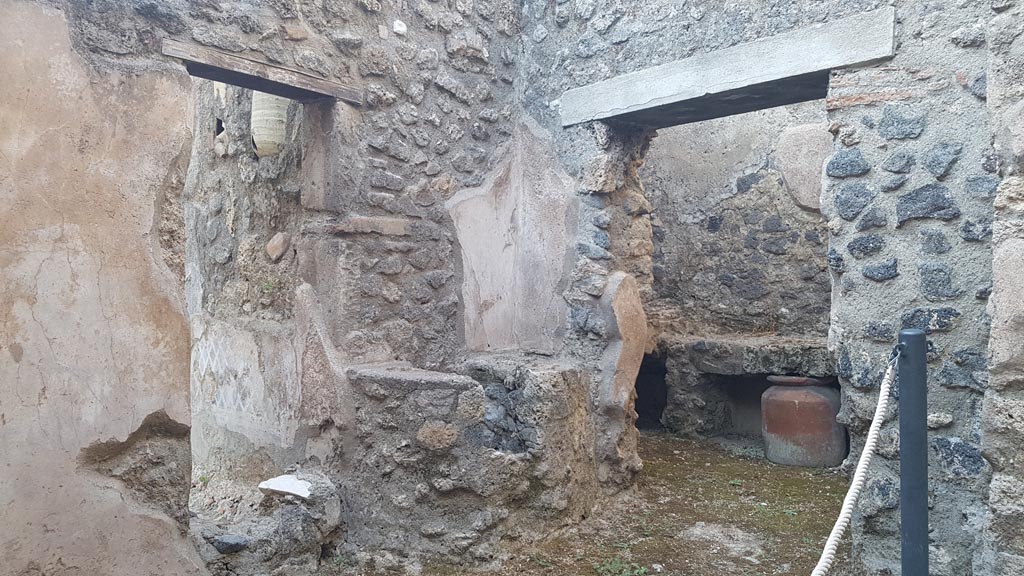 I.7.19 Pompeii. August 2023. 
Small room on north side of corridor with two doorways, one to garden area, the other to kitchen. Photo courtesy of Maribel Velasco.

