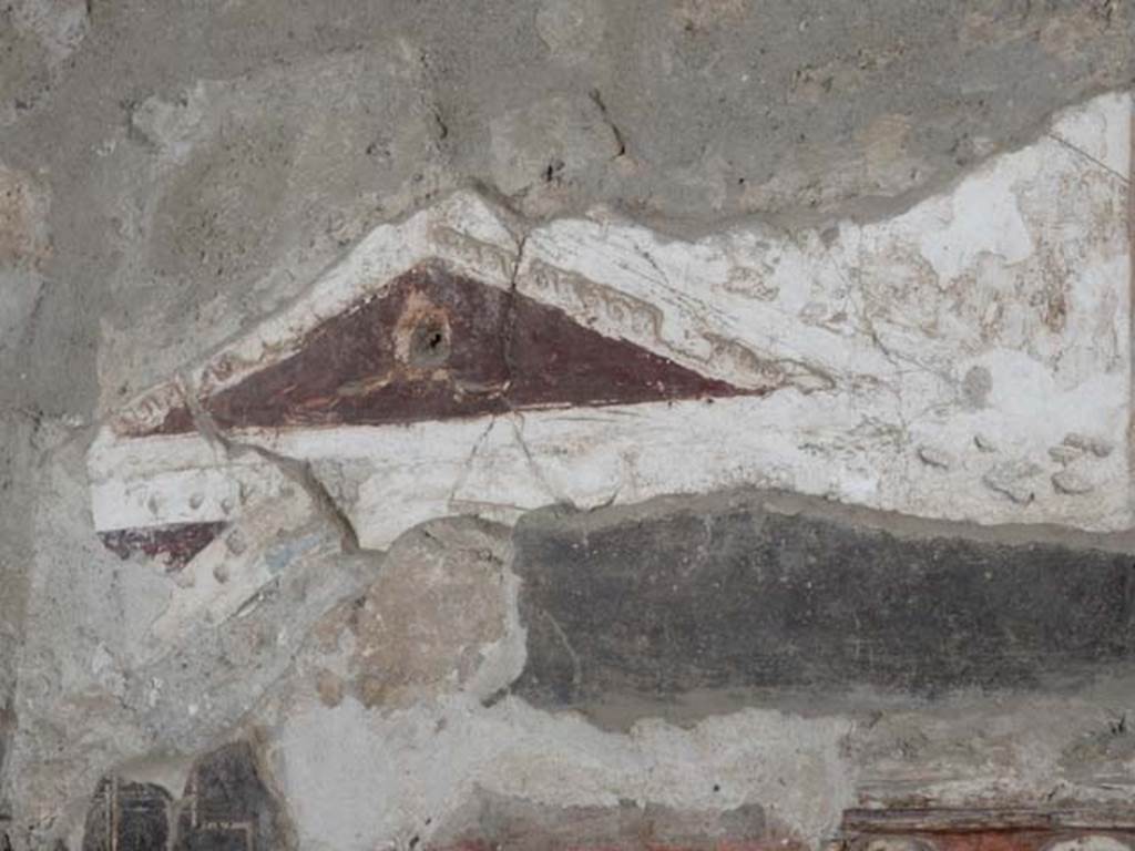 I.8.8 Pompeii. May 2015. Detail of stucco decoration on south wall, with east side of pediment above lararium. Photo courtesy of Buzz Ferebee.
