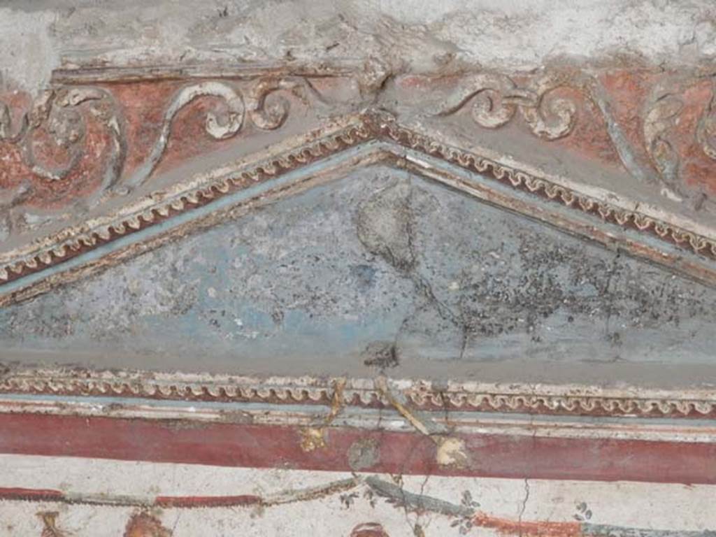 I.8.8 Pompeii. May 2015. Detail of stucco decoration on south wall, with west side of pediment above lararium. Photo courtesy of Buzz Ferebee.
