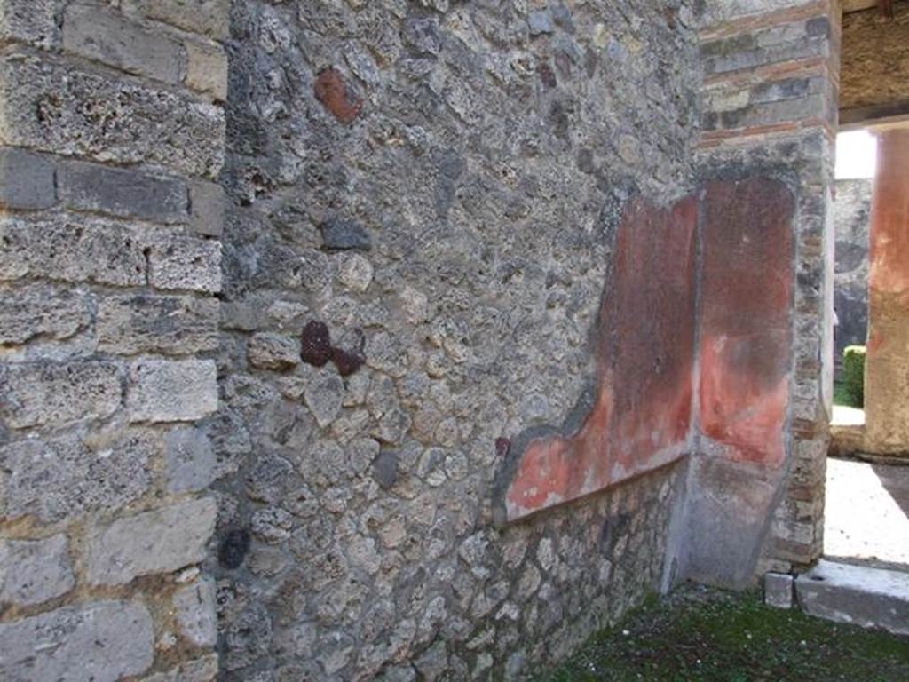 I.8.9 Pompeii. March 2009. Room 5, east wall of tablinum, looking towards south-east corner. On the south wall at the east side, the black zoccolo and red panel of the middle zone can be seen.
