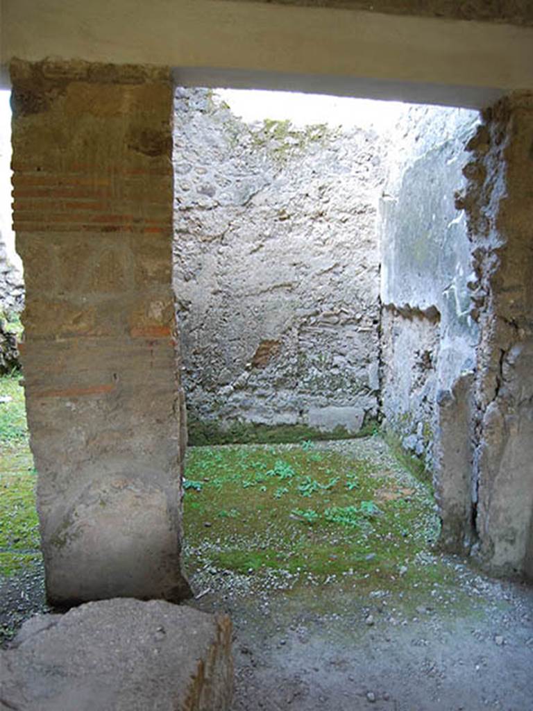 I.8.15 Pompeii. December 2007. Looking north across bar-room, with counter.  
According to Sampaolo (in PPM) -
“On the west wall, in 1936 a painting was discovered and removed. 
Painted above the zoccolo, was a painting in which the characters were identified by names painted in black, in capital italic letters.
The scene divided into three panels of different lengths by wide red bands, showed six characters in short pink tunics (the first, third, and sixth from left) going to the right,  each carrying on their shoulder, two cages suspended by a stick.  
They were walking among bushes under an unusual structure, probably a gabled pergola, hung with garlands. 
On the extreme right, there was a smaller female figure, dressed in a long green tunic, with her arm raised pointing to welcome the six characters that she was looking at. 
Starting from the left, and written near their heads, the names were –
Fortunatus, C. Iulius Trophimus, Felix, C. Marcius Fortunatus, G. Castricius Seno, D. I(uventi)us Eunus (Nautilo?)”.
See PPM, (p.846), where the painting was described as being found on the west wall.
See Rivista di Studi Pompeiani, Vol. III, 1989, article by Castiglione, V., Del Franco, M., and Vitale, R: “L’insula 8 della Regio I, un campione d’indagine socio-economica”, (p.185-221). 
On page 206-7, figs.22 and 23, is a photograph of the fresco and a reconstruction, but the caption states that it was from the east wall.
