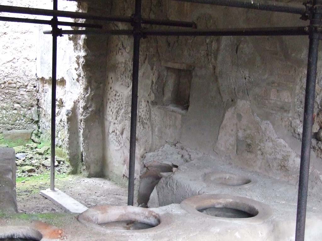 I.8.15 Pompeii. May 2003. Looking north across counter with five remaining embedded dolia, and a broken one, centre right. Photo courtesy of Nicolas Monteix.
