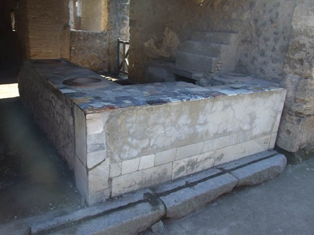 I.9.4 Pompeii.  March 2009.  Marble counter and display shelving.