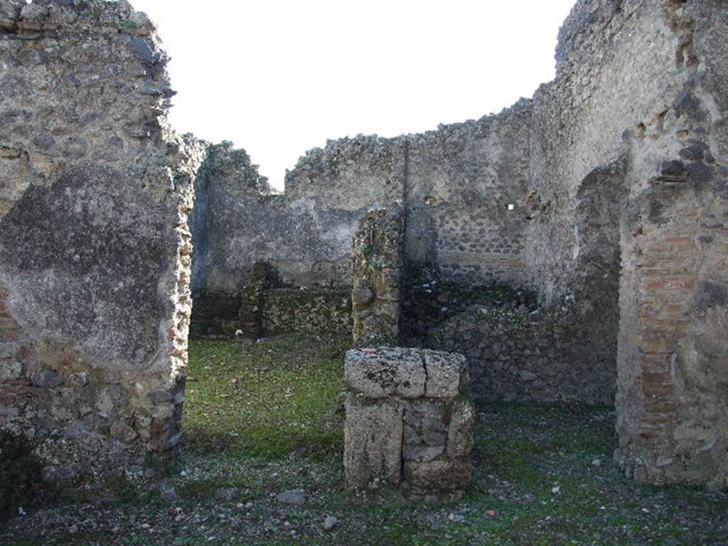 I.9.10 Pompeii. December 2006. South wall of atrium with doorways to three rooms.   On the left, the kitchen, in the middle at the rear a storeroom, and doorway on the right to a small room, possibly another storeroom.
