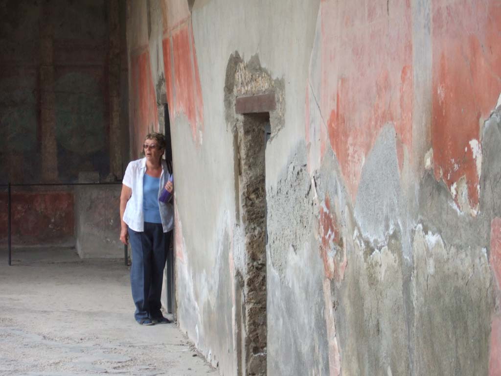 I.10.4 Pompeii. May 2006. 
West portico, with doorway to room 46 the baths entrance, and doorway to corridor M, leading to the kitchen and services area.
