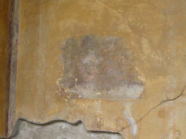 I.10.4 Pompeii. October 2017. Alcove 23, looking towards south wall.
Foto Annette Haug, ERC Grant 681269 DCOR.
Alcove 23, south wall, 
painted masks, on left, with possibly Bacchus sitting on a chair with robe covering his legs in central panel, and painted table, on right.
See Kuivalainen, I., 2021. The Portrayal of Pompeian Bacchus. Commentationes Humanarum Litterarum 140. Helsinki: Finnish Society of Sciences and Letters, (p.104, B17).

