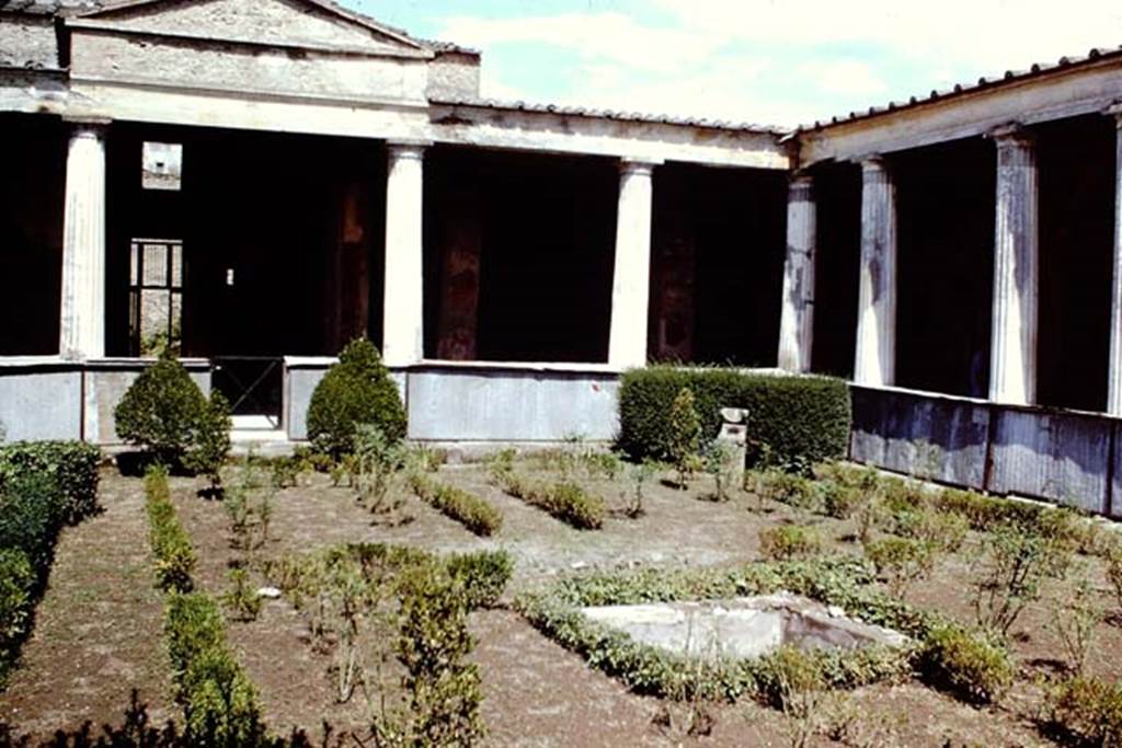 I.10.4 Pompeii, 1968. Looking towards north and north-east corner of peristyle. Photo by Stanley A. Jashemski.
Source: The Wilhelmina and Stanley A. Jashemski archive in the University of Maryland Library, Special Collections (See collection page) and made available under the Creative Commons Attribution-Non-Commercial License v.4. See Licence and use details.
J68f1001
According to Jashemski 
The imprint of a wooden triclinium, which occupied a rectangular area 1.74 x 2.69m, was found in the garden, and on the south side of the triclinium was a square pool with a fountain. There was a spherical sundial in the north-east of the garden.
See Jashemski, W. F., 1993. The Gardens of Pompeii, Volume II: Appendices. New York: Caratzas. (p.47).

According to Soprano 
Ubiczione: peristilio.
Bibliog. Maiuri, La Casa del Menandro e il suo tesore di argenteria. (Roma, 1939), p.84 and fig.a on p.75.
Nel peristilio furono rinvenute le impronte di un triclinio ligneo. 
Occupava unarea rettangolare di m.1.74 per 2.69; ad ovest del triclinio cera una piscina quadrata.
See Soprano, P. (1950). I triclini allaperto di Pompei. (In Pompeiana, raccolta di studi per il secondo centenario degli scavi di Pompei. Napoli, Gaetano Macchiaroli, Editore, P. 307, no.31).

