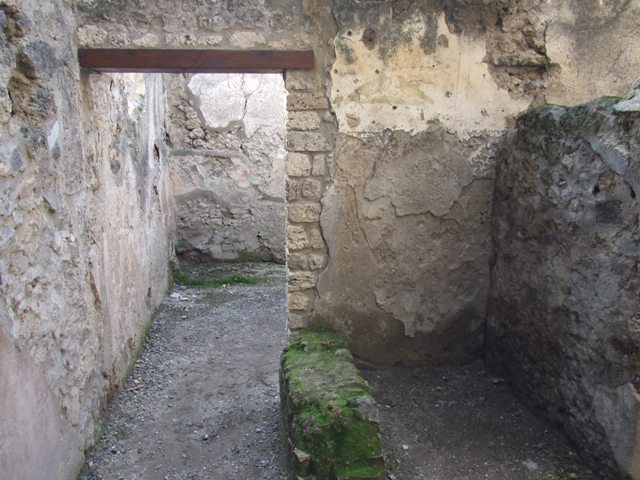 I.10.6 Pompeii. September 2015. Looking west through doorway of small room to east of workshop, with remaining bird wall painting. 
