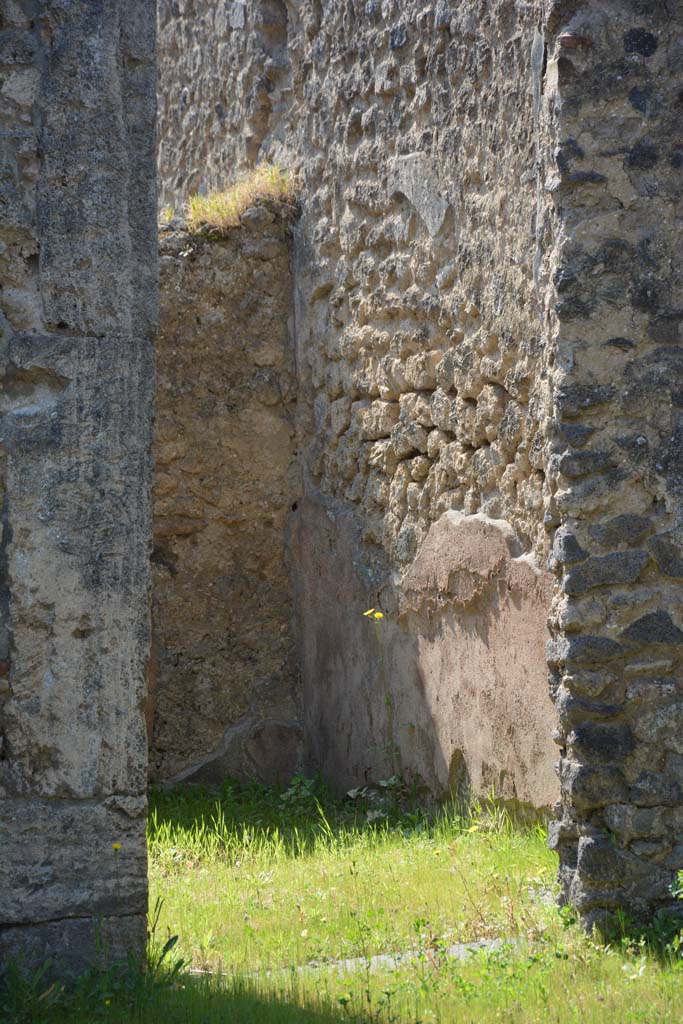 I.10.8 Pompeii. April 2017. Room 8, looking south through doorway towards west wall with remains of high zoccolo.
Photo courtesy Adrian Hielscher.
