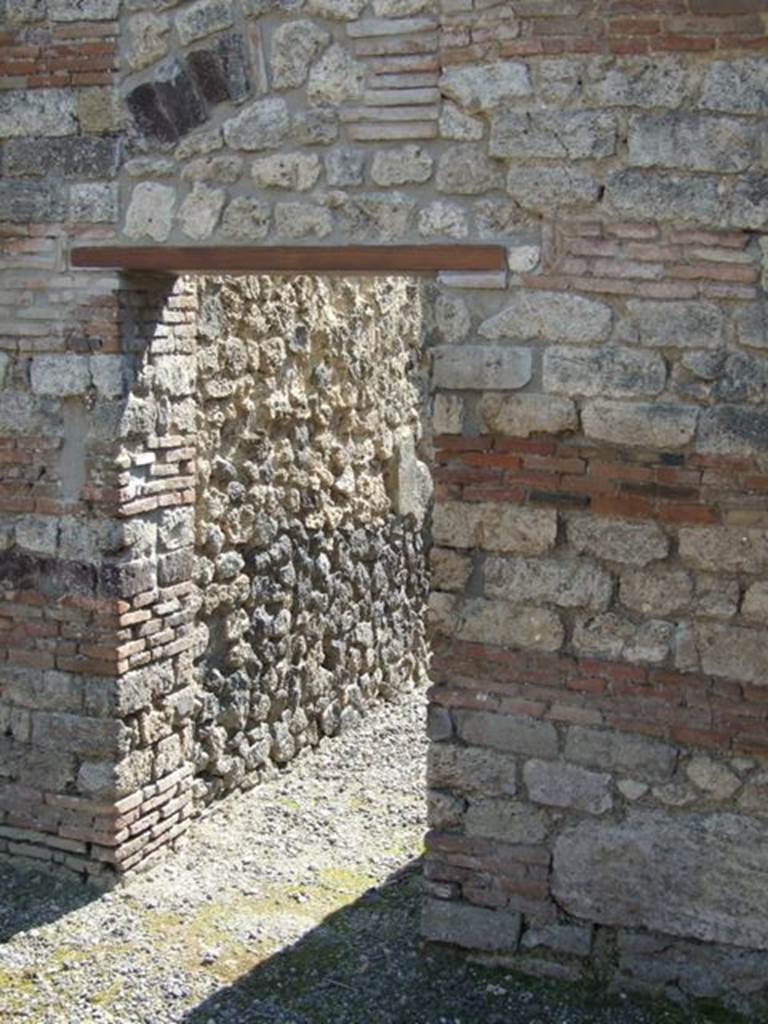 I.10.8 Pompeii. March 2009. Doorway to room 7, the corridor to rear.