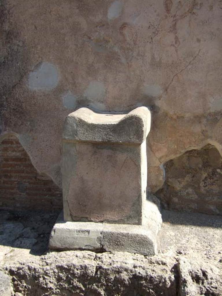 Street altar on west side wall of I.11.1, September 2005.

According to Della Corte, found written in charcoal probably by a passer-by was CIL IV 8426:
[Per] Lares sanctos rogo tu et…… [CIL IV 8426]
This was written, approximately in the left top corner of the photo, although none of the wording has been conserved.

According to Epigraphik-Datenbank Clauss/Slaby (See www.manfredclauss.de) it read as -
[Per] Lares Sanctos 
rogo te ut [                  [CIL IV 8426]

According to Cooley, CIL IV 8426, appears to the left of a street corner shrine, where a painting of a Lar and a snake can still be faintly seen.
On top of the altar were found the carbonised remains of a sacrifice of a chicken.
She translates the wording as  –
“By the sacred Lares, I ask you …..”  [CIL IV 8426]
See Cooley, A. and M.G.L., 2004. Pompeii : A Sourcebook. London : Routledge. (p.109)
