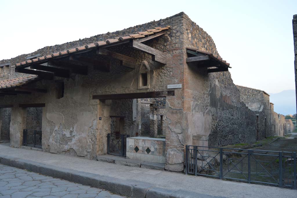 I.11.1 Pompeii. October 2017. 
Looking south-east towards entrance doorway, on left, and street altar in small roadway, on right.
Foto Taylor Lauritsen, ERC Grant 681269 DÉCOR.
