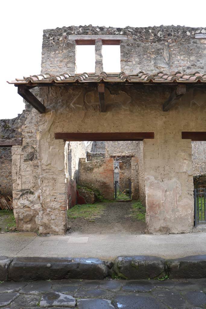 I.11.3 Pompeii. December 2018. 
Entrance doorway with window above, on south side of Via dellAbbondanza. Photo courtesy of Aude Durand.
