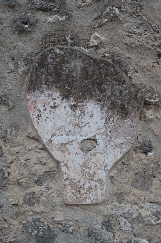 I.11.7 Pompeii. October 2018. Detail of remaining stucco on wall to south of street altar.
Foto Taylor Lauritsen, ERC Grant 681269 DÉCOR.
