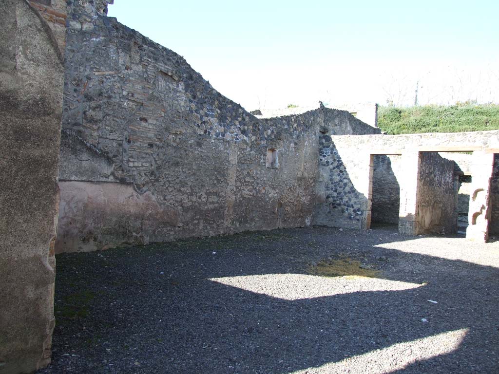 I.11.8.Kitchen with site of stairs to upper floor on left and site of latrine on right