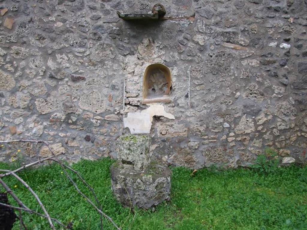 I.11.10 Pompeii. December 2006. Aedicula lararium on east wall with a second masonry altar in front of it. According to Wilhelmina, a small terracotta head of Jupiter, a votive offering was found in the vicinity of this area. 
See Jashemski, W. (2014). Discovering the Gardens of Pompeii: Memoirs of a Garden Archaeologist. (p.125)

